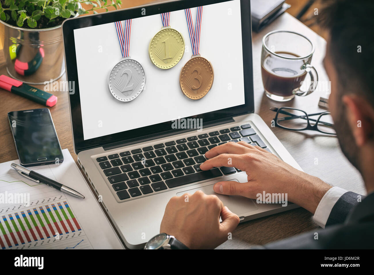 Set of medals - golden, silver and bronze - on a laptop screen Stock Photo