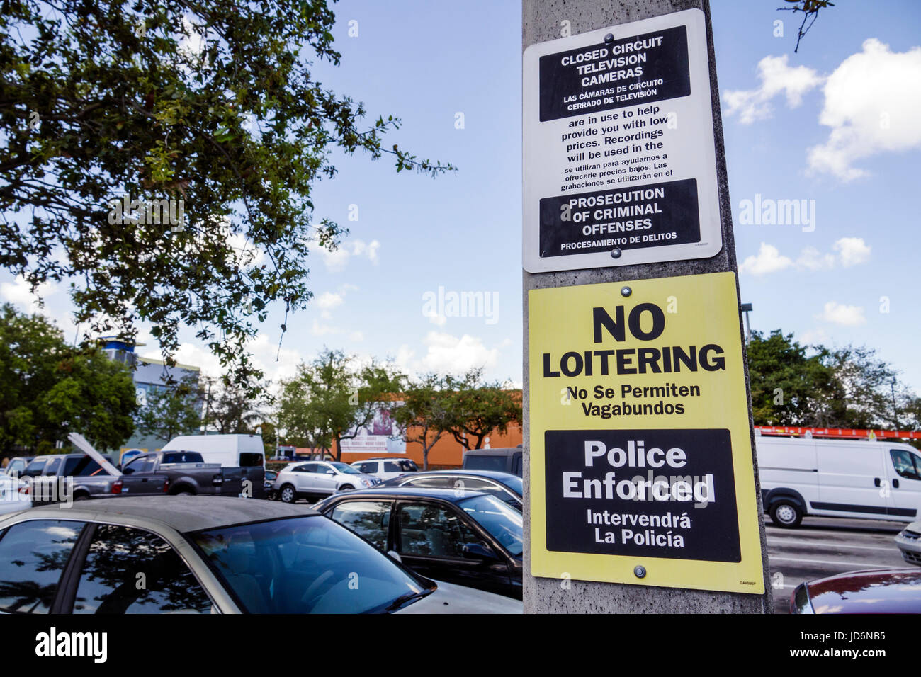 Miami Florida,Little Havana,Home Depo,parking lot,sign,no loitering,bilingual,Spanish,English,language,no homeless permitted,police enforcement,prosec Stock Photo