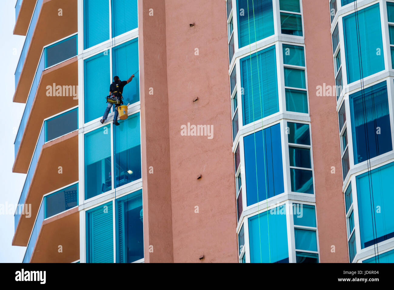 Miami Beach Florida,South Pointe SoFi,Portofino Tower,skyscraper,building,exterior,window washer,bosun’s chair,boatswain,harness,bucket,squeegee,dange Stock Photo