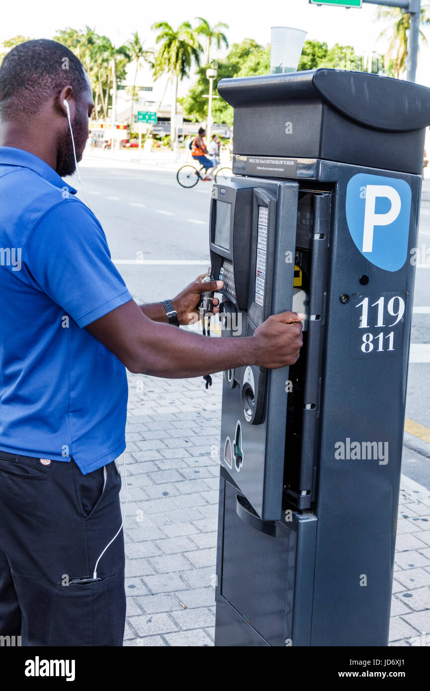 Miami Florida,Downtown,Biscayne Boulevard,parking ticket pay machine,pay by plate,technician,Black man men male,job,opening cover,repairing,repairman, Stock Photo