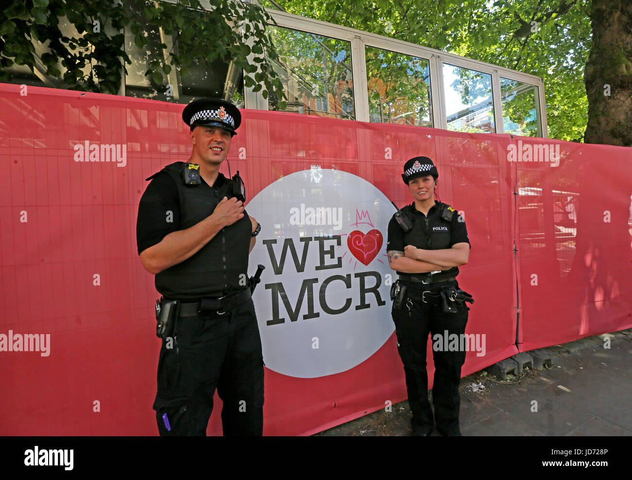 Manchester, UK. 18th June, 2017. Police officers stood next to a 'We Love MCR' sign, Manchester, 18th June, 2017  Credit: Barbara Cook/Alamy Live News Stock Photo