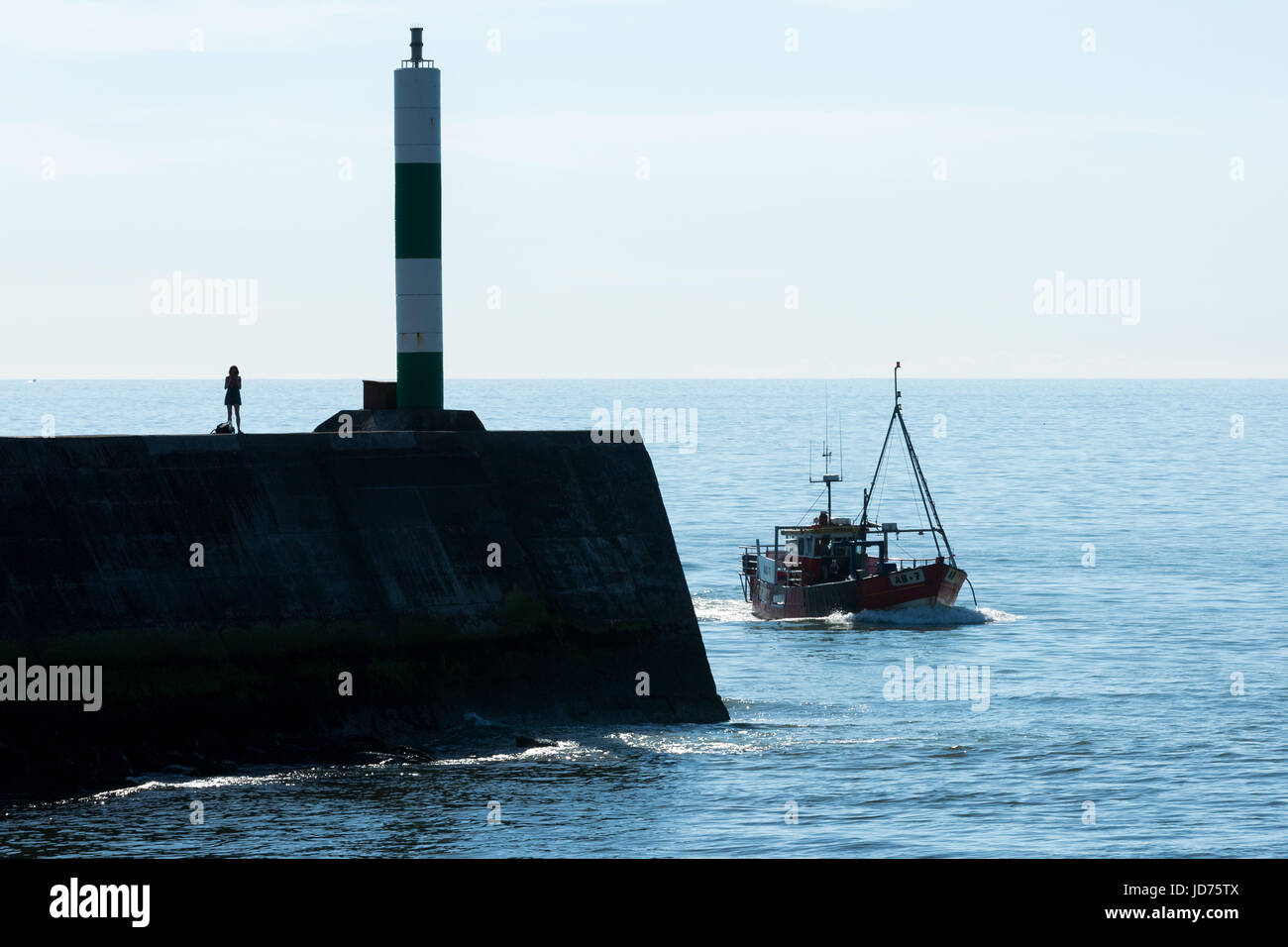 A fishing boat entering Aberystwyth harbour Stock Photo - Alamy