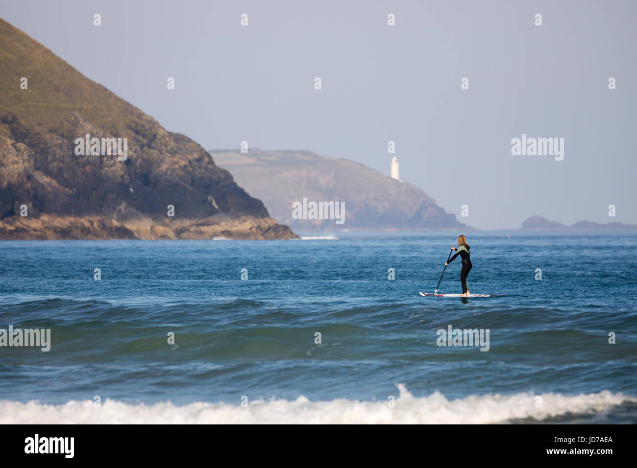 Female paddle boarder paddle boarding at the renowned surfing beach of