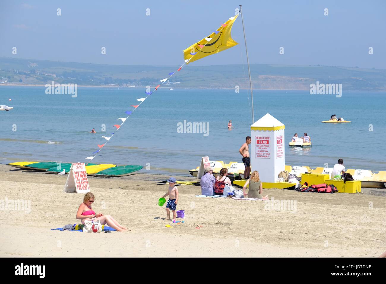 Weymouth, Dorset, UK. 19th June, 2017. Beach goers enjoy the hot weather on Weymouth beach as the Government issue a level three heat alert on a day where temperatures are expected to peak at 34C in parts of the UK bringing the hottest June day since 1976. Credit: Tom Corban/Alamy Live News Stock Photo