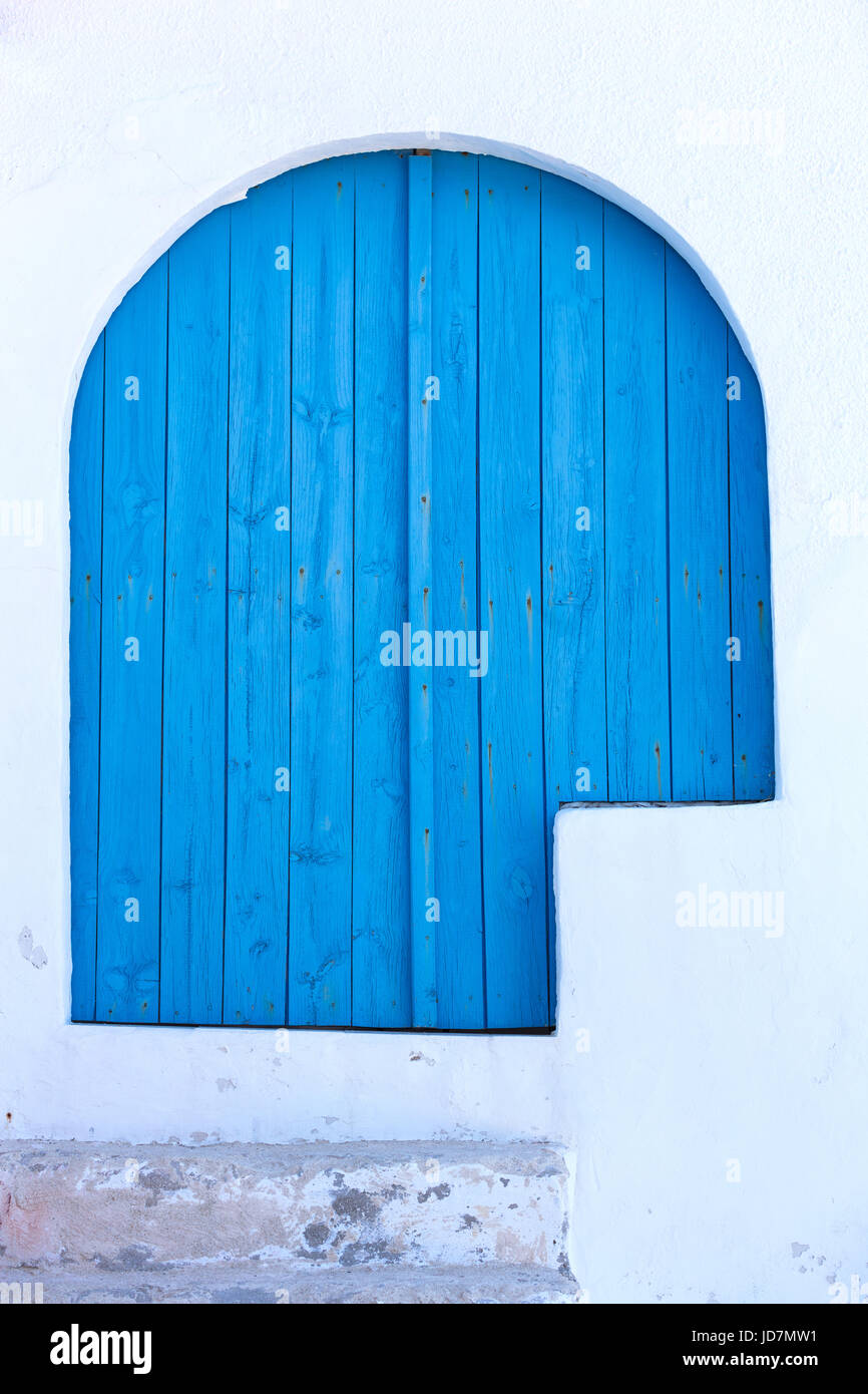 intense blue wooden door in a white wall, mediterranean colors Stock ...