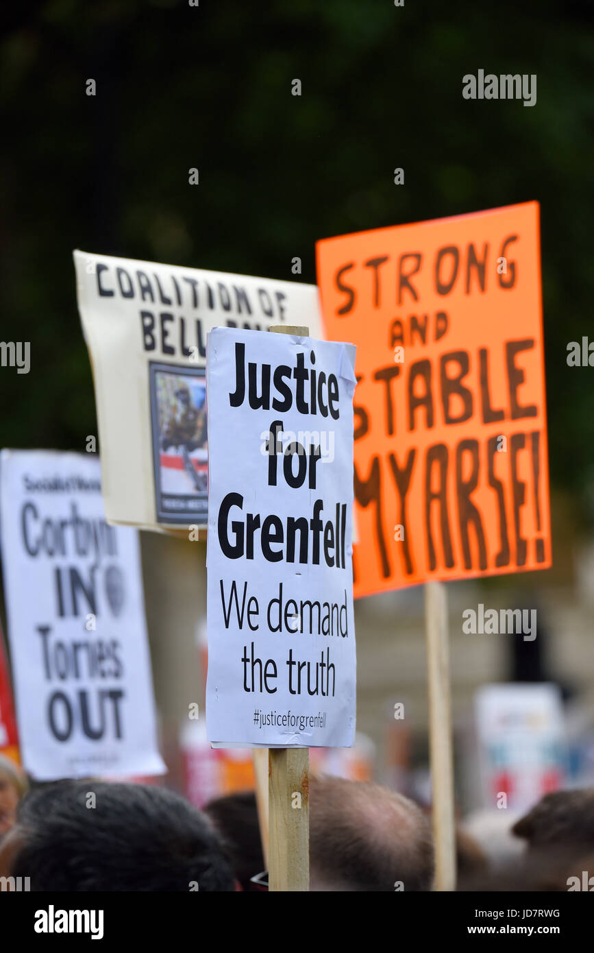 Anti Tory DUP alliance and justice for grenfell demonstration outside Downing Street in Whitehall, London. Placards and protesters Stock Photo