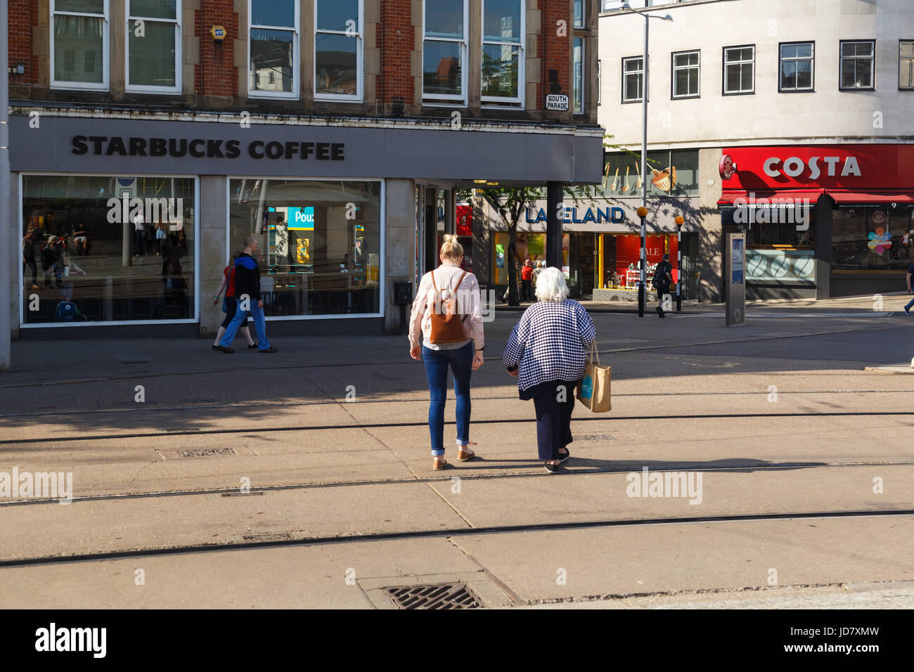 NOTTINGHAM, ENGLAND - JUNE 17: Mother and daughter walking towards Starbucks/Costa coffee shop. In Nottingham, England. On 17th June 2017. Stock Photo
