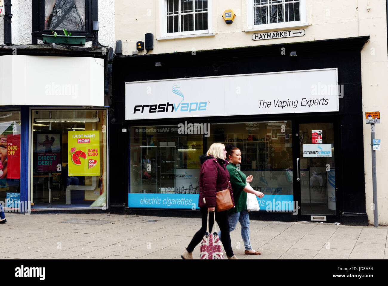 People passing a Fresh Vape vaping shop in Norwich, Norfolk, England Stock Photo