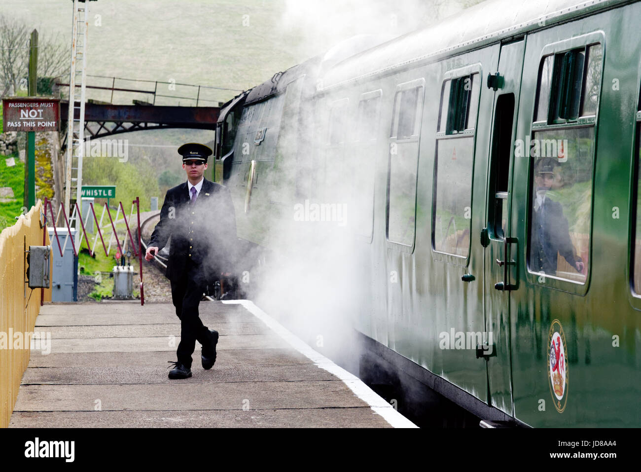 The Station master on the platform at Corfe Castle on the Swanage Railway steam railway Stock Photo