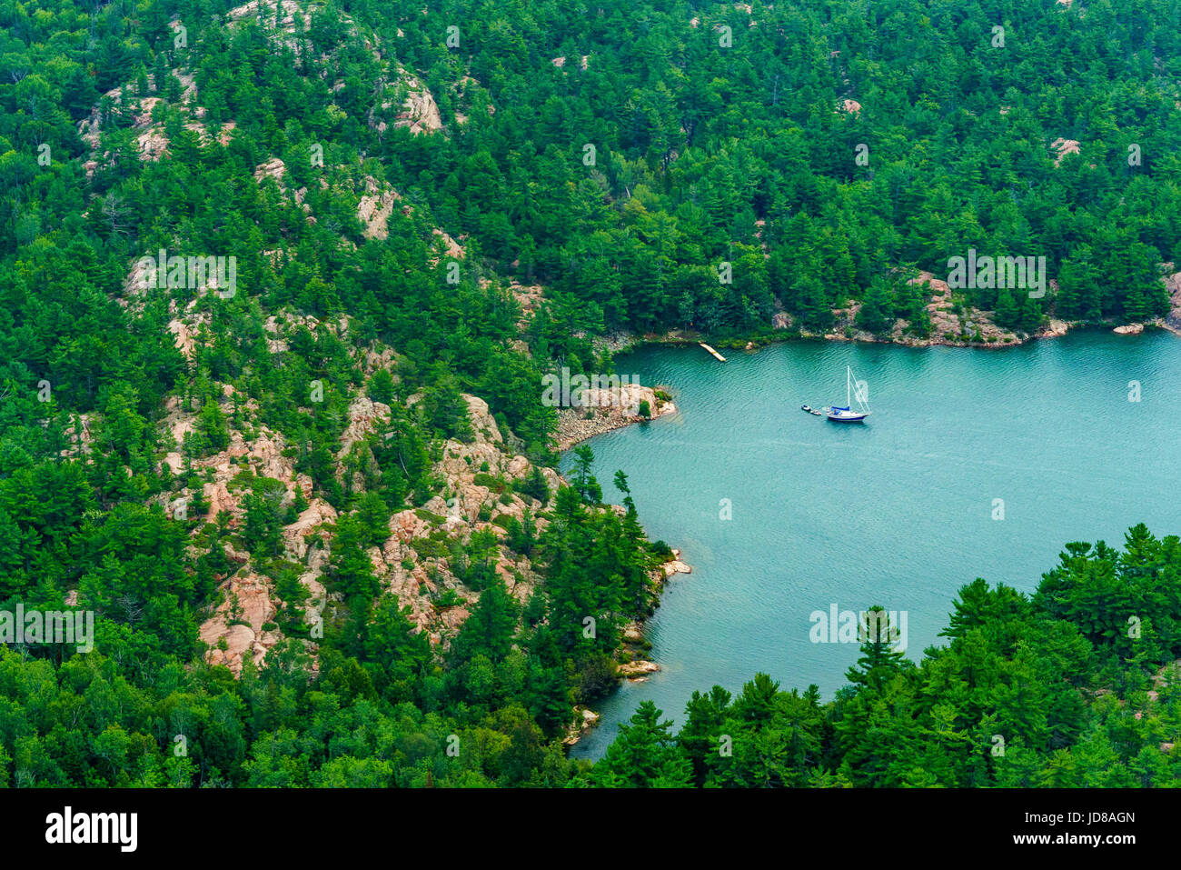 Boat on lake surrounded by mountains and trees, Toronto, Ontario, Canada. aerial picture from ontario canada 2016 Stock Photo