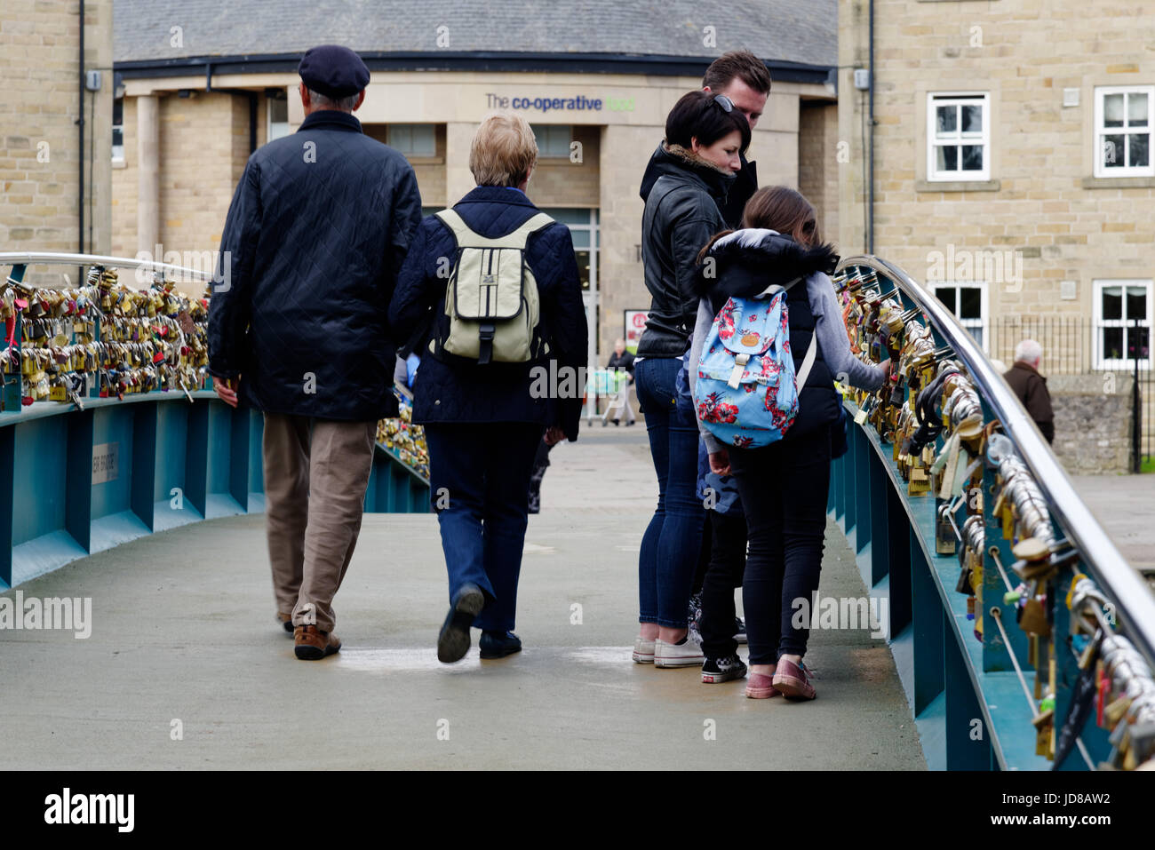 People looking at love locks on Bakewell Bridge in Bakewell, Derbyshire