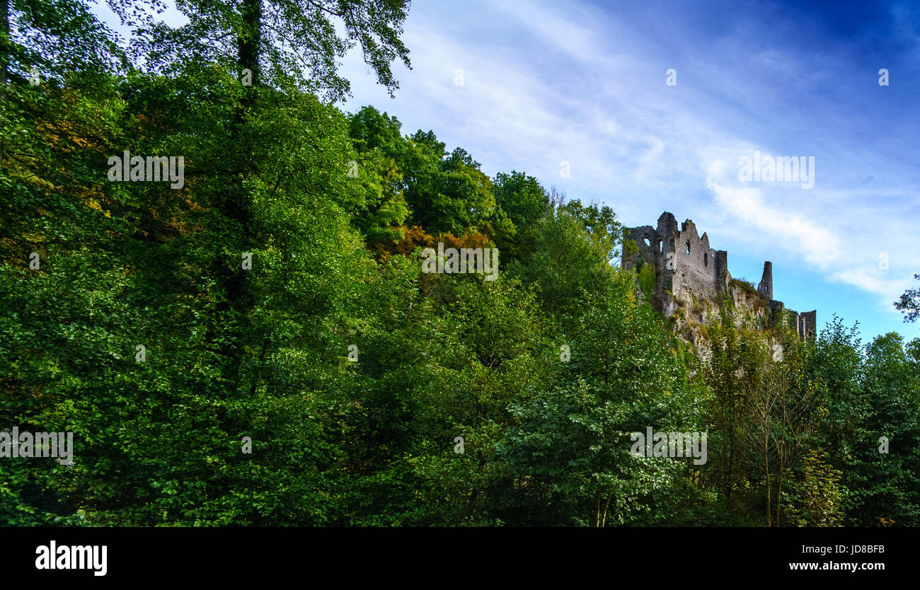Ruined old stone building nestled amongst green trees on hillside, Belgium. belgium europe Stock Photo