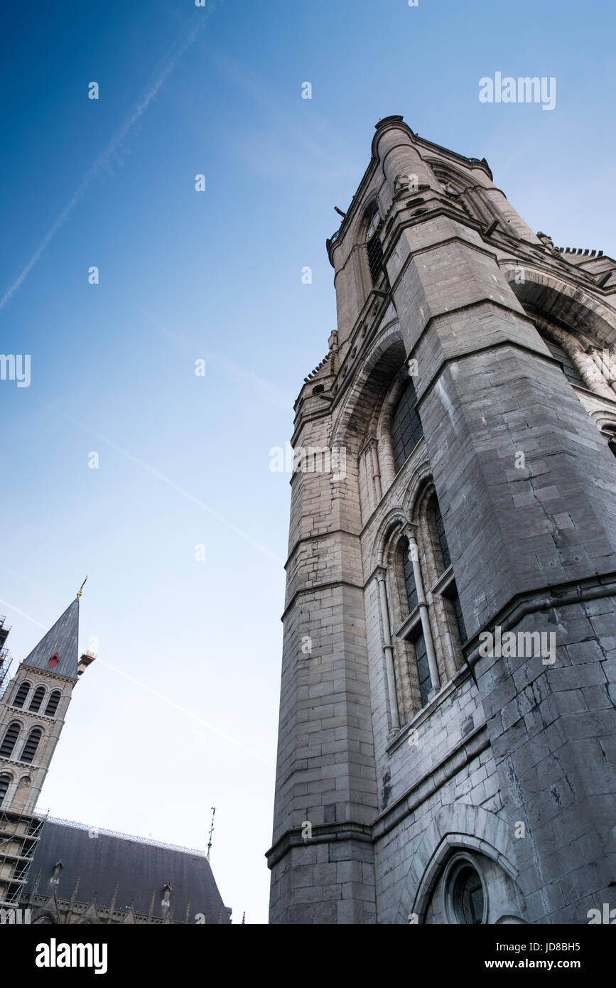 Old stone traditional tower against clear blue sky, low angle, Belgium. tournai old town belgium europe Stock Photo