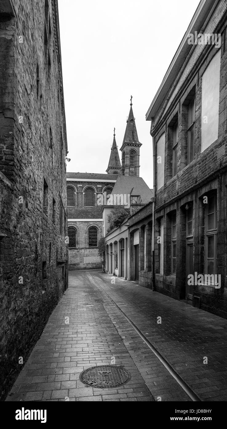 View through traditional buildings and cobbled street in town, Belgium. Stock Photo