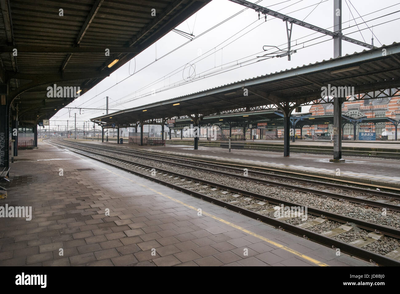 Railway station platform and train tracks with awning above, Belgium. colour picture train transportation Stock Photo