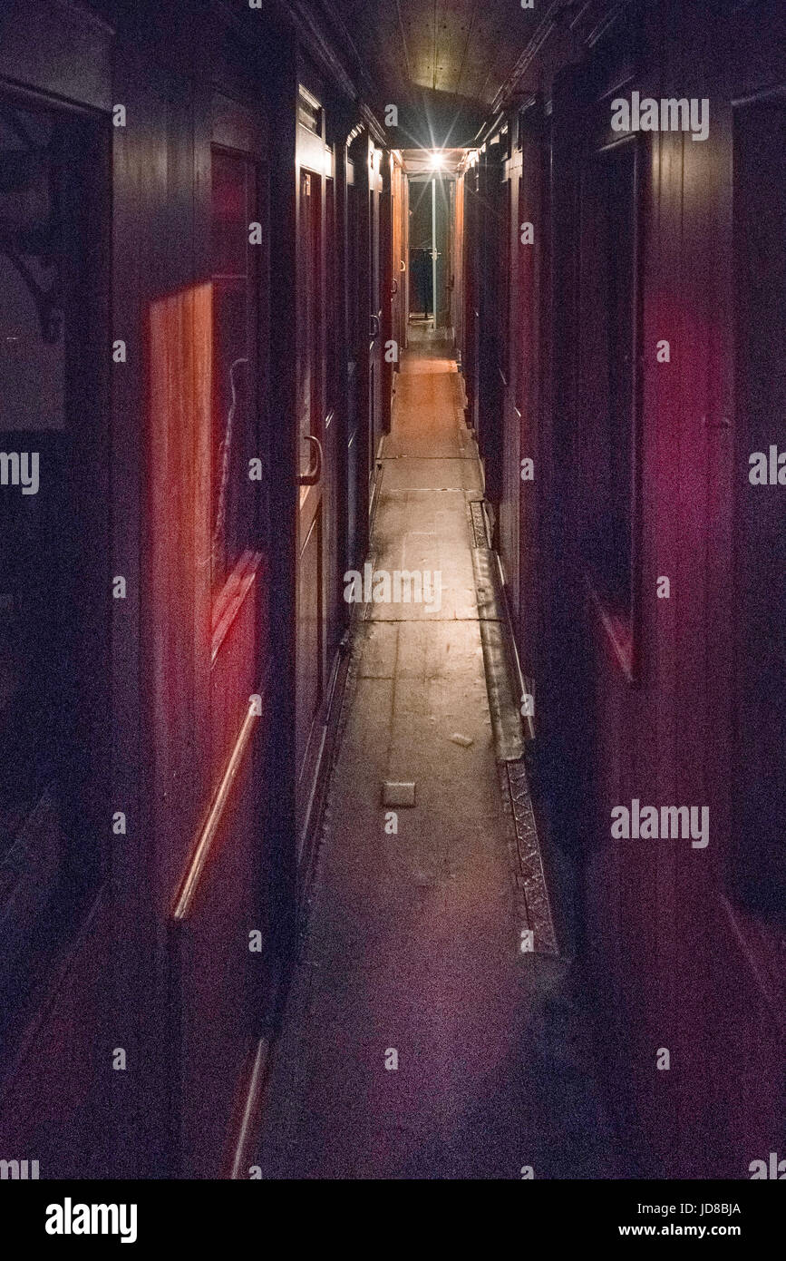 View along dark narrow empty corridor of old fashioned train. colour picture train transportation Stock Photo