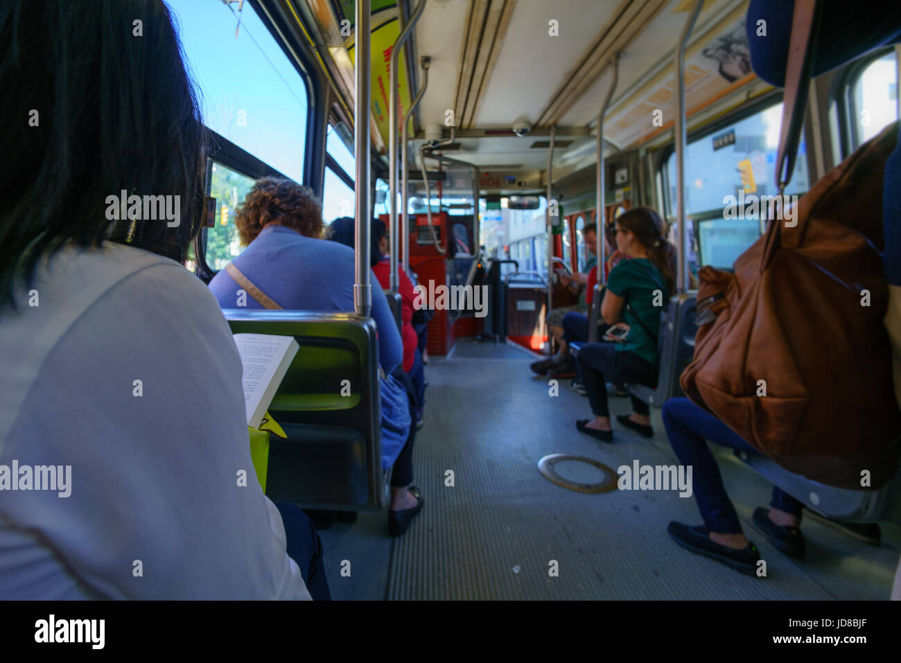 View of inside bus with passengers travelling at day time. Stock Photo