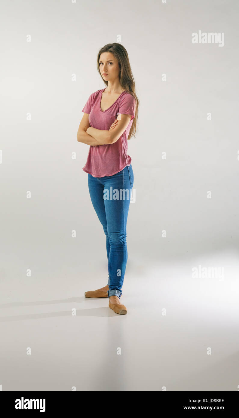 Female ballet dancer standing with arms crossed wearing casual clothing, studio shot. caucasian fit pretty skinny athletic Stock Photo