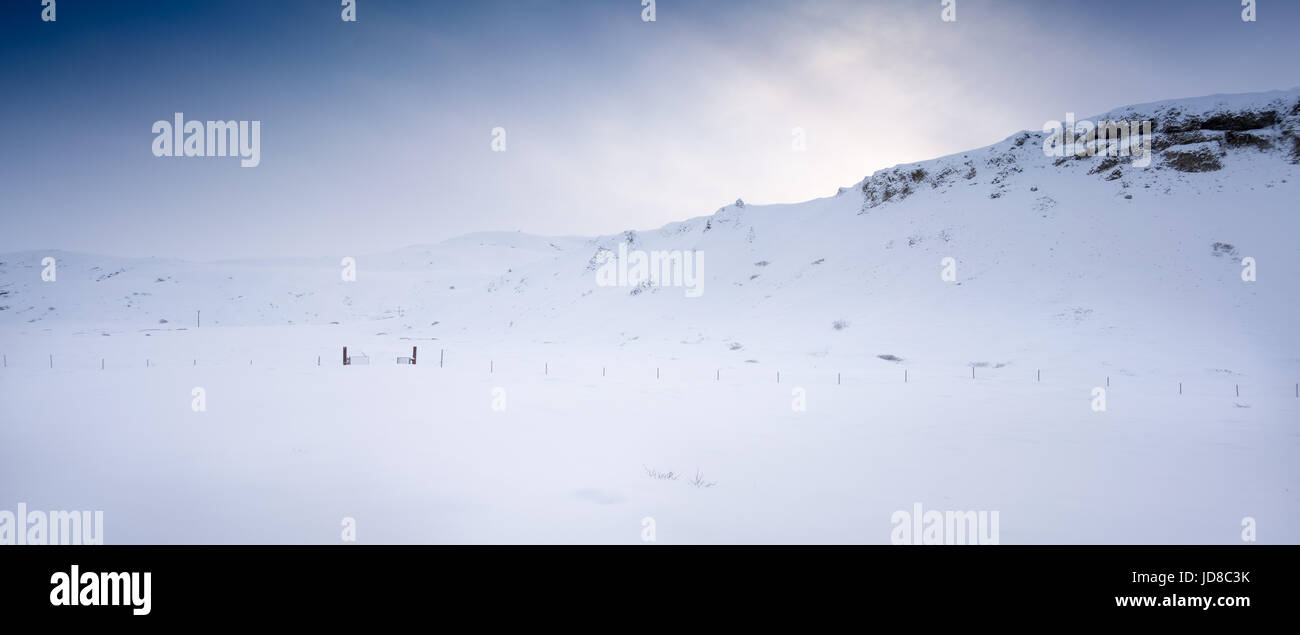 Horizontal, snow covered landscape, hill and sun glare, Iceland, Europe. Iceland nature 2017 winter cold Stock Photo