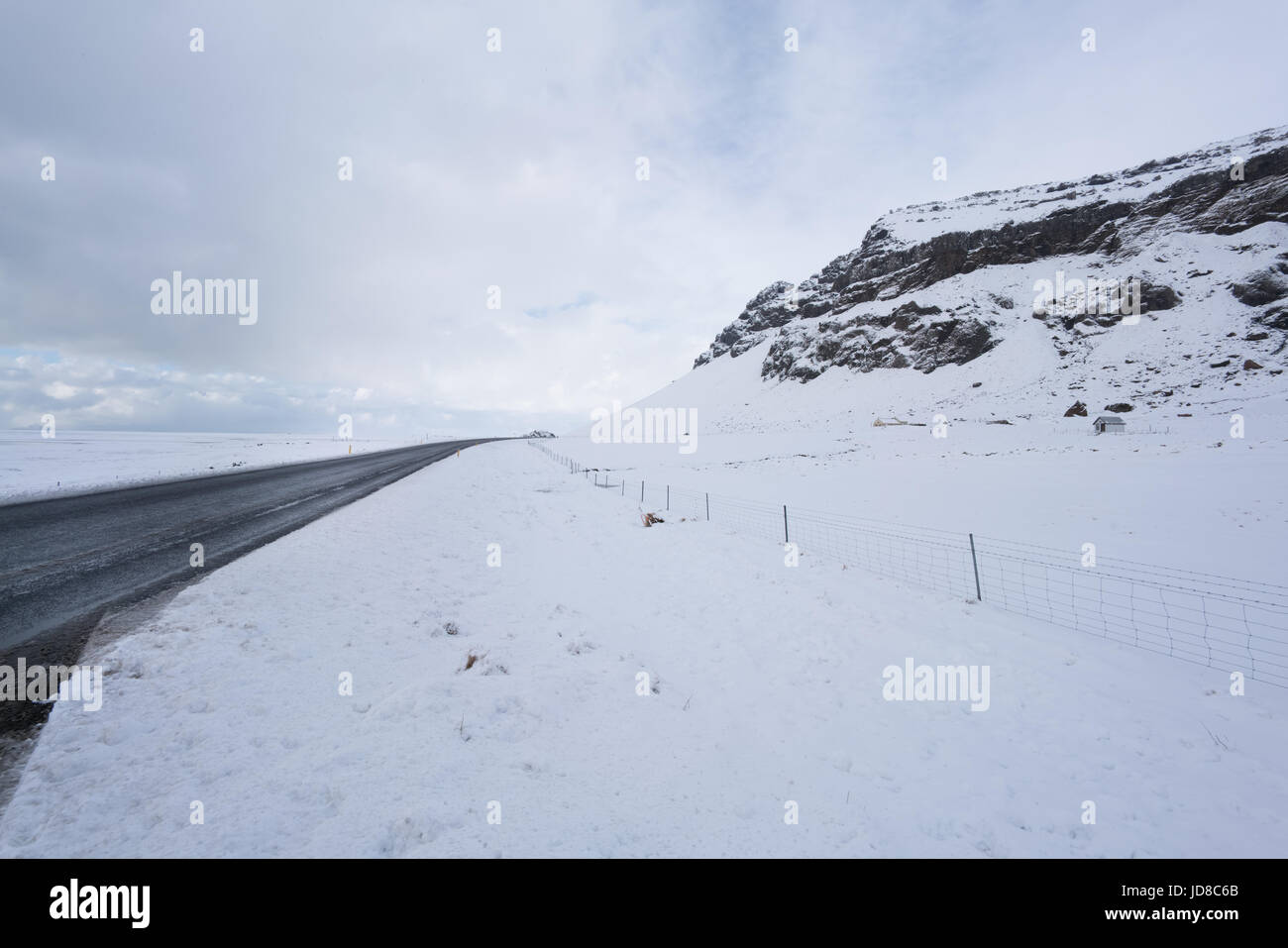 Snow covered landscape and road, diminishing perspective by day, Iceland, Europe. Iceland nature 2017 winter cold Stock Photo