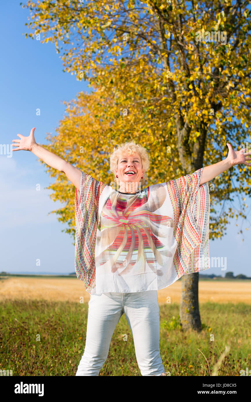 Old woman happy arms in air hi-res stock photography and images - Alamy