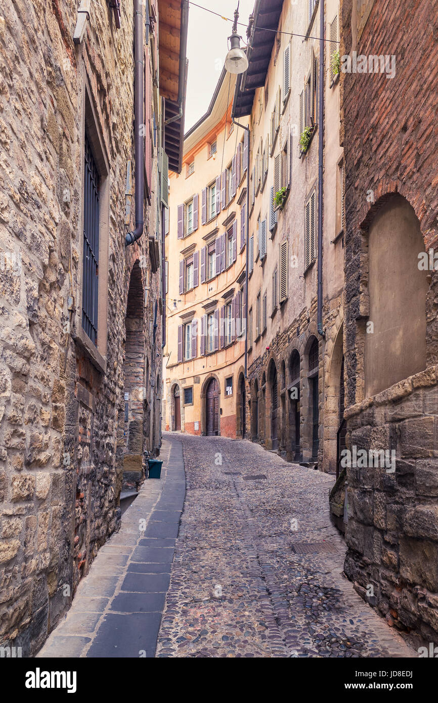Narrow old stone streets of Bergamo Alta, surrounded by houses and ancient walls, Italy Stock Photo