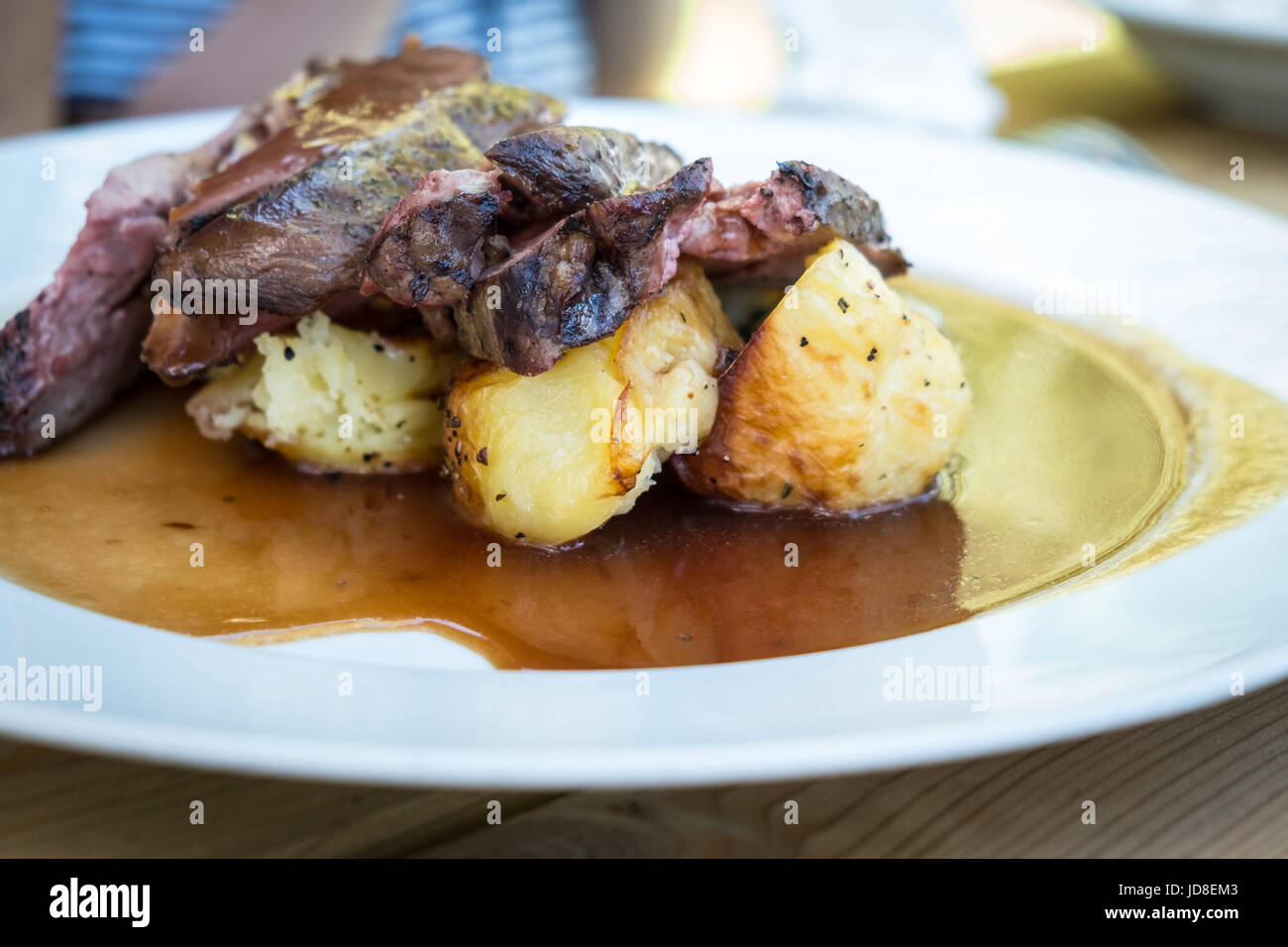 Lamb shank without bones with baked potatos Stock Photo - Alamy