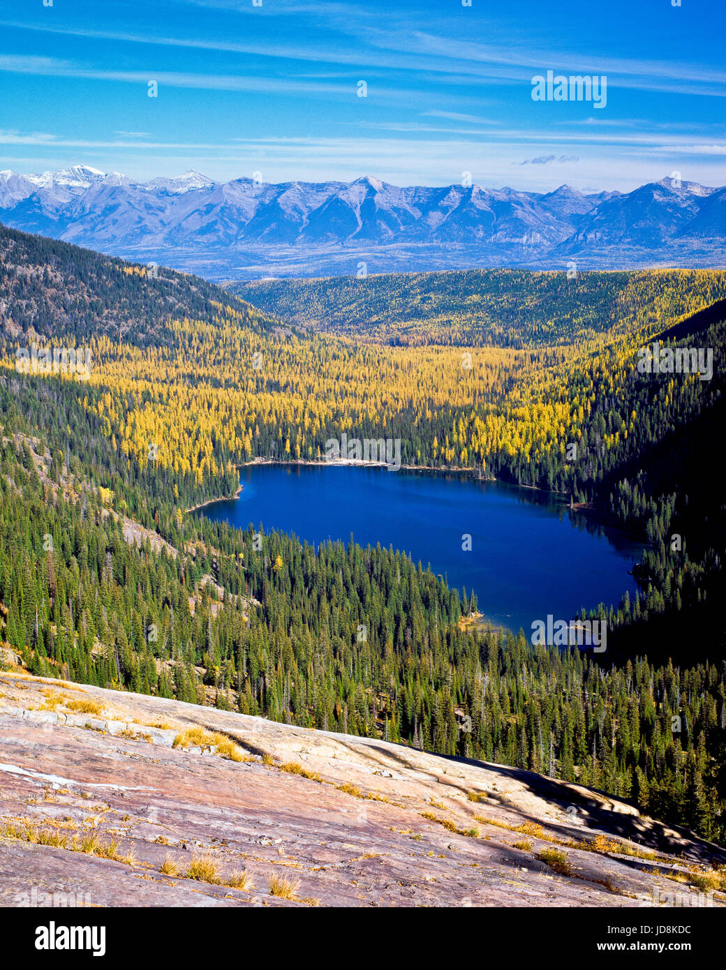 glacier lake and autumn larch in the mission mountains above the swan valley, with the swan range in the distance near condon, montana Stock Photo
