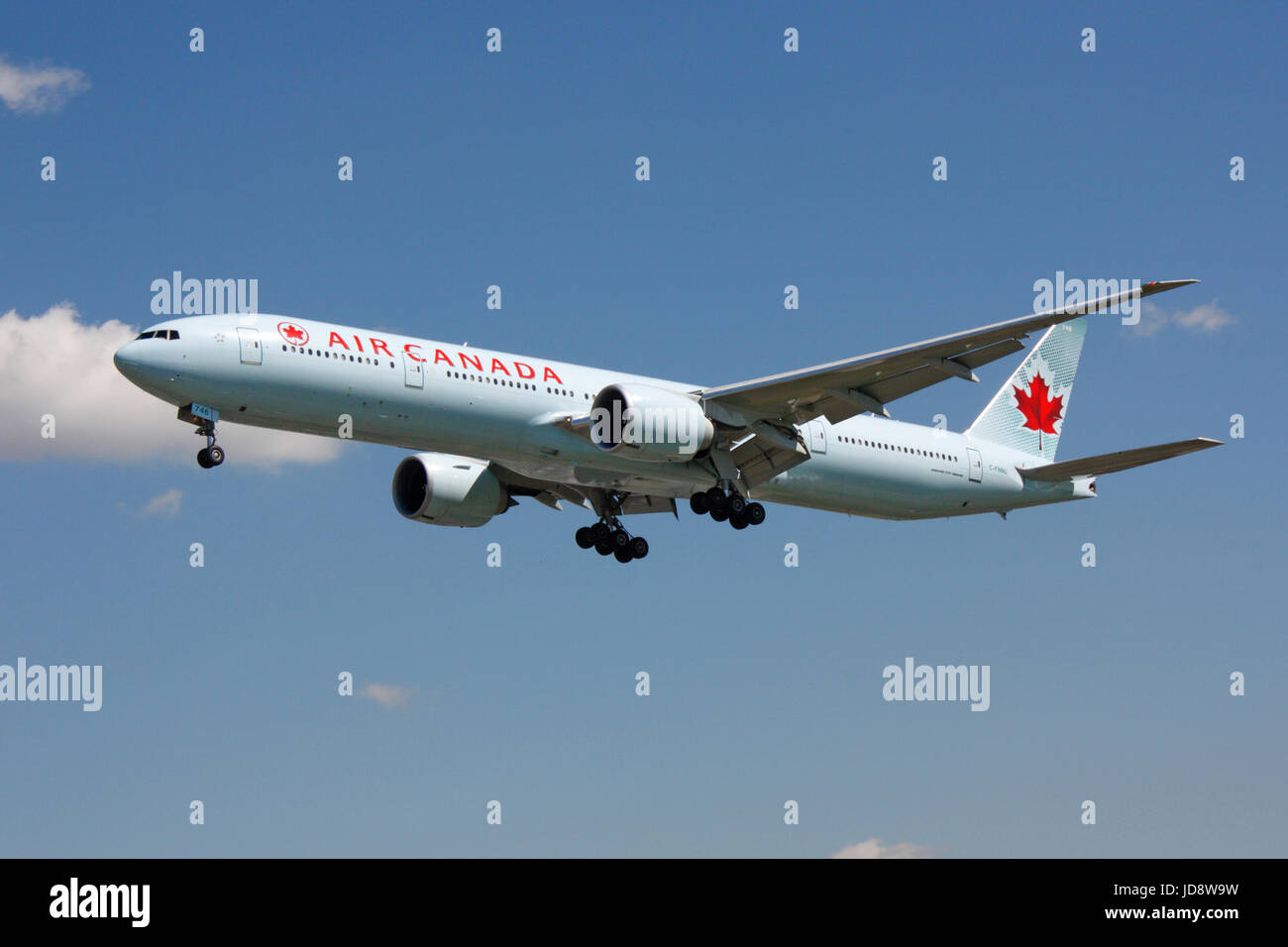 Commercial aviation and transatlantic flight. Air Canada Boeing 777-300ER long haul passenger jet plane on approach to London Heathrow. Stock Photo
