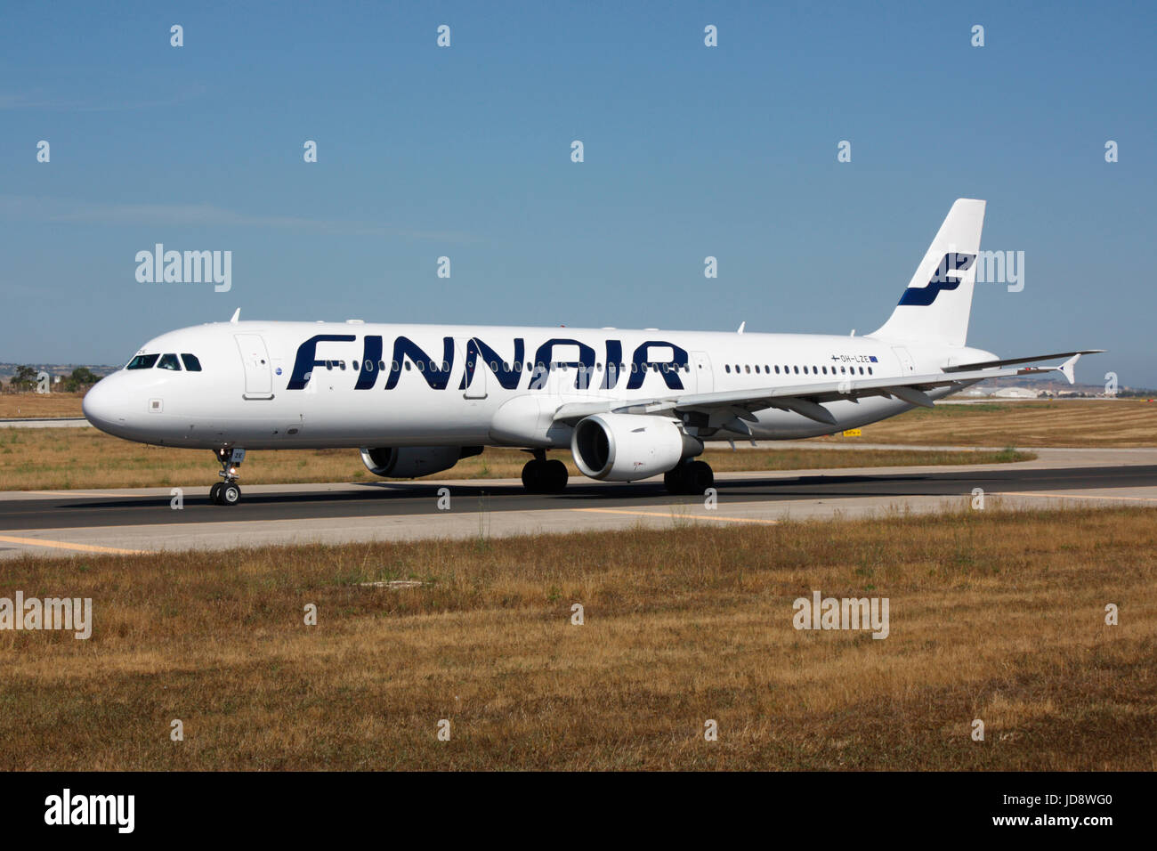 Commercial air travel. Airbus A321 passenger jet plane in the colours of Finnish airline Finnair taxiing on airport taxiway for departure from Malta Stock Photo