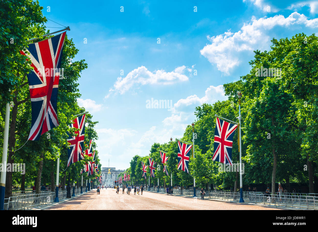 Tourists on the Mall walking southwest towards Buckingham Palace in the City of Westminster, London Stock Photo