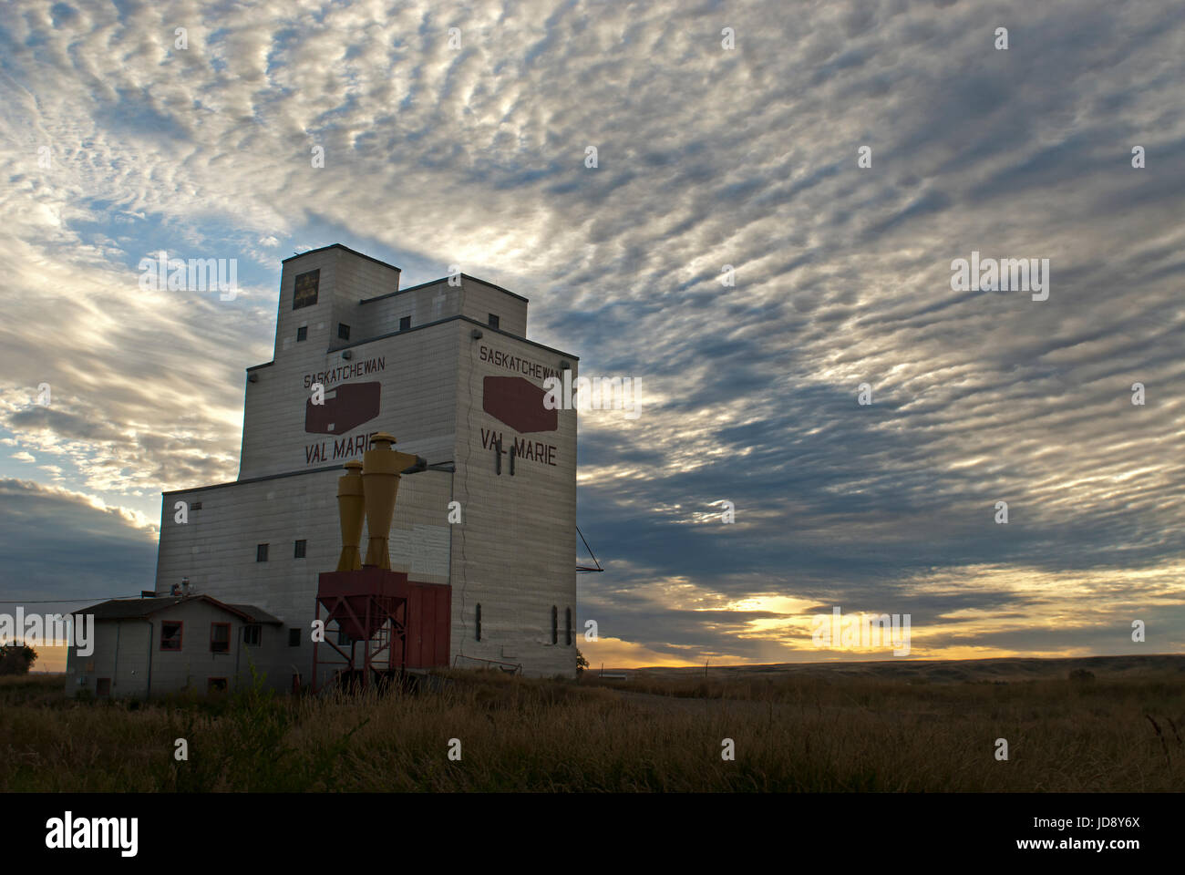 Grain elevator in early morning sunrise. Stock Photo