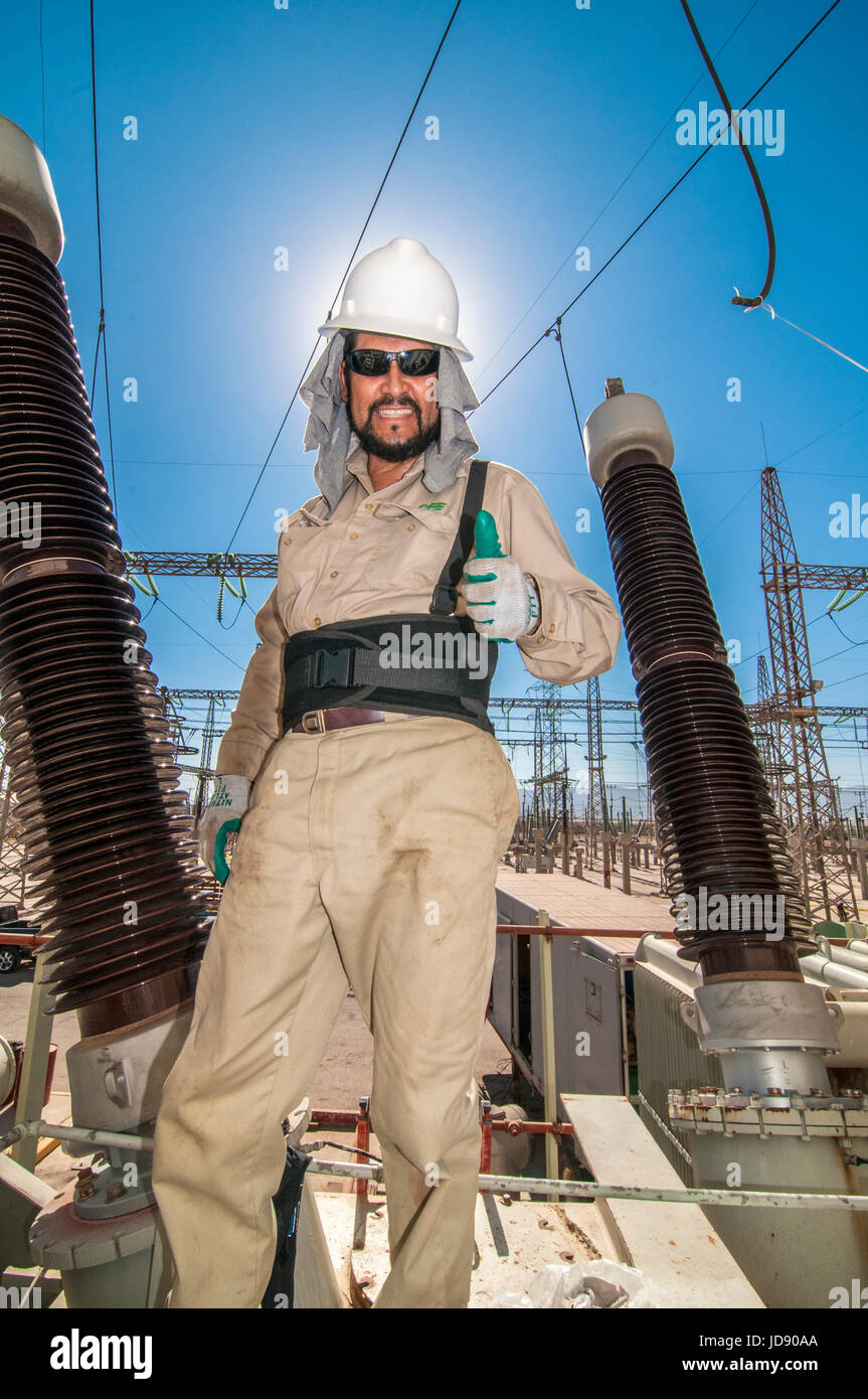 Utility Electric Worker Performing Power Transformer Maintenance And