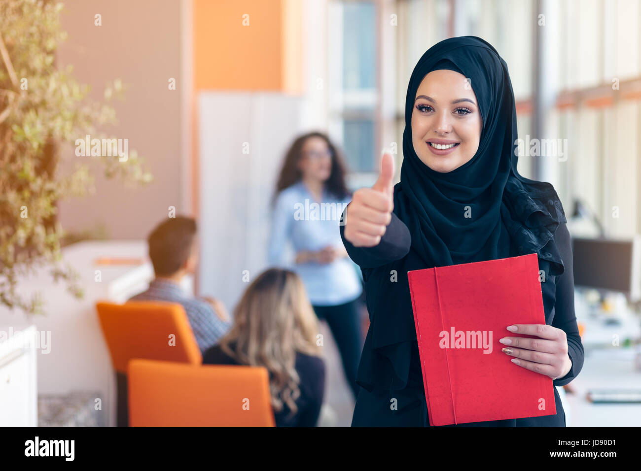 Arabian business woman with hijab holding a folder Stock Photo - Alamy