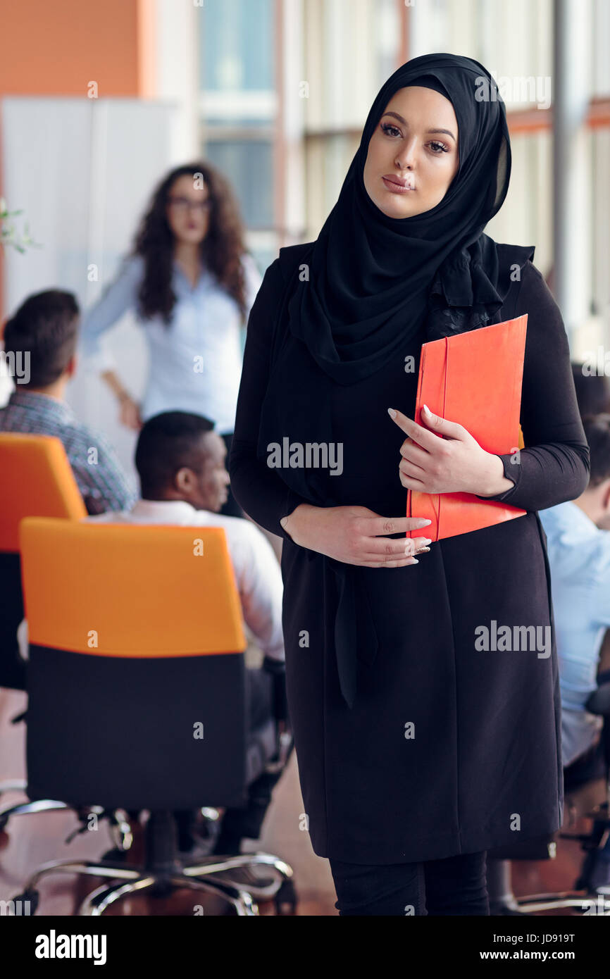 Arabian business woman with hijab holding a folder Stock Photo - Alamy