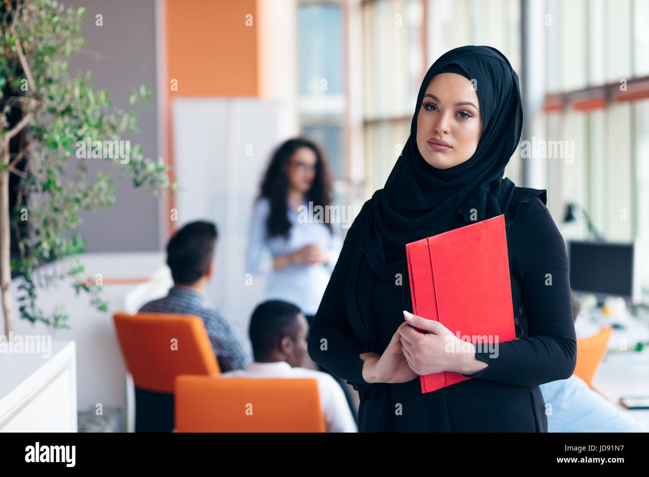 Arabian business woman with hijab holding a folder Stock Photo - Alamy