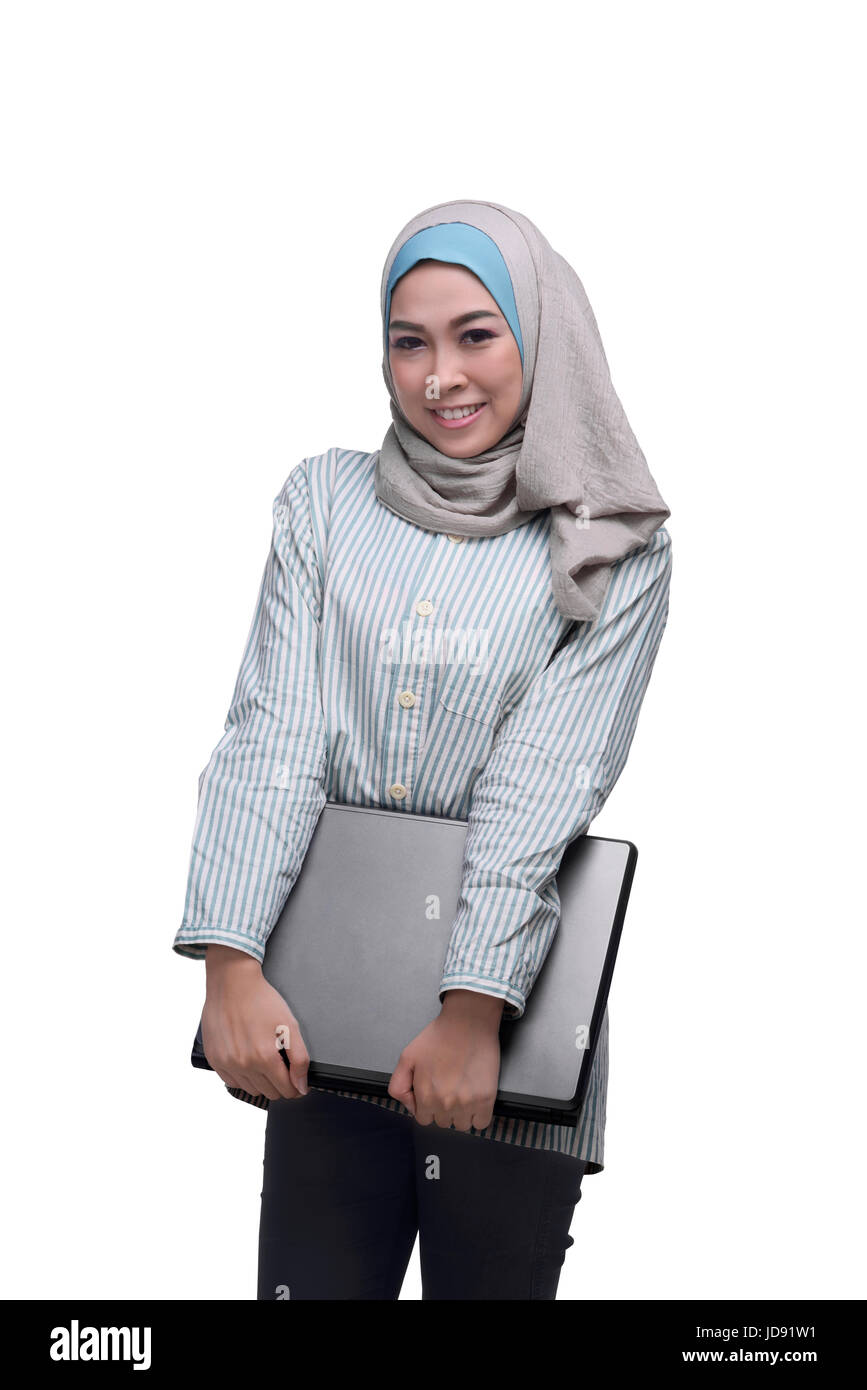 Beautiful asian muslim woman holding laptop isolated over white ...