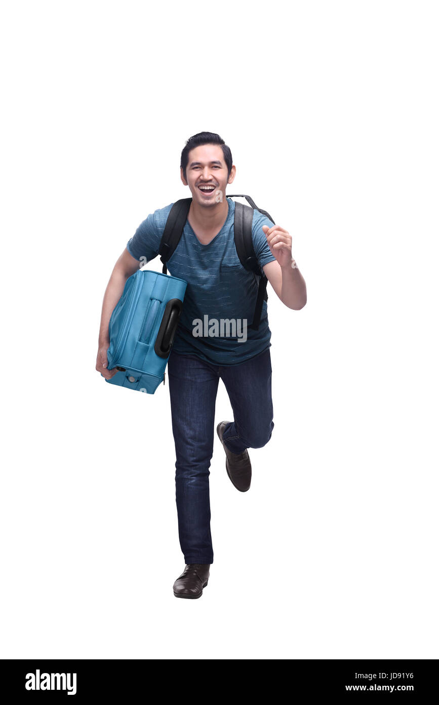 Attractive asian travelling man with suitcase running isolated over white background Stock Photo