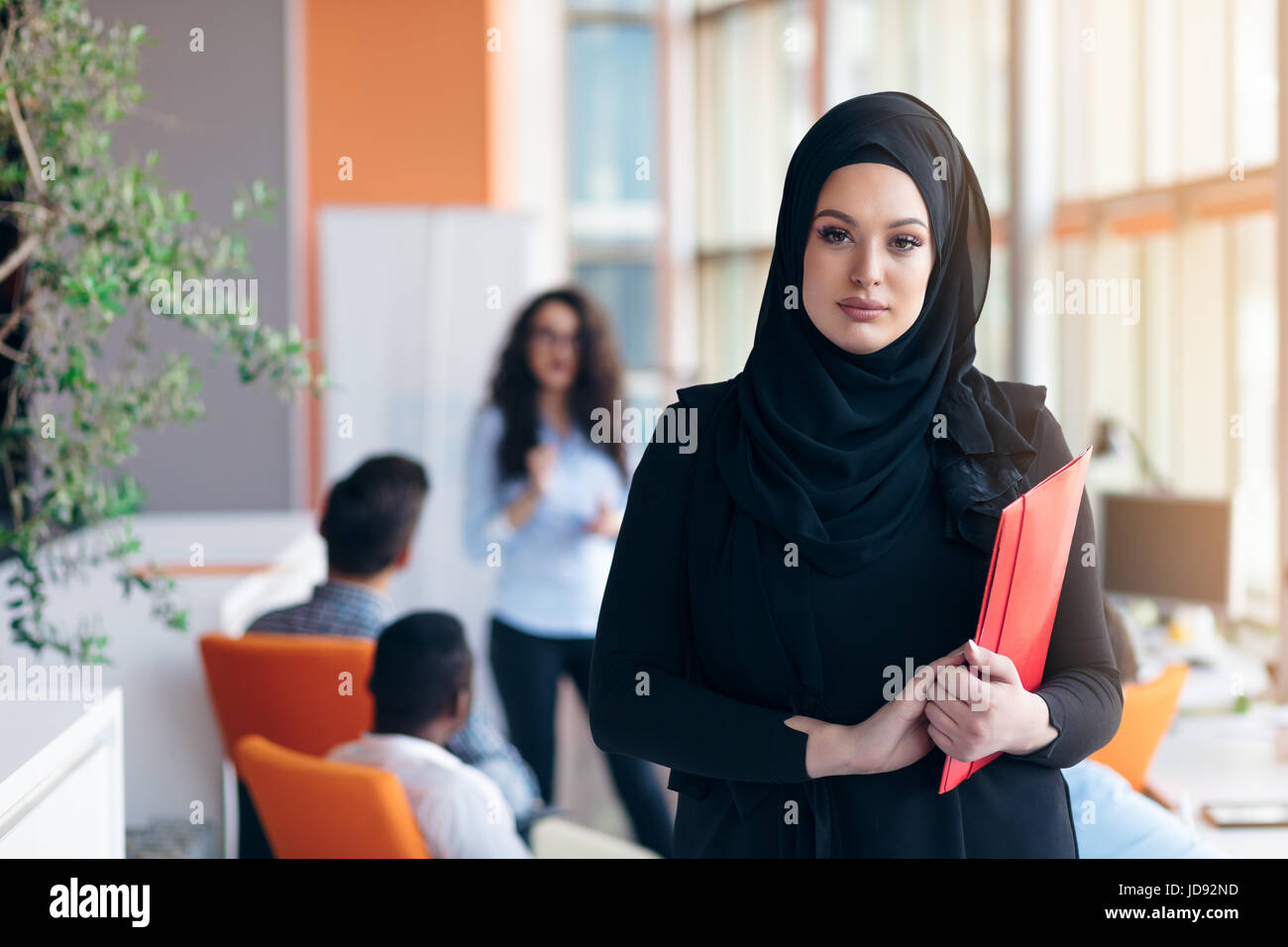 Arabian business woman with hijab holding a folder Stock Photo - Alamy