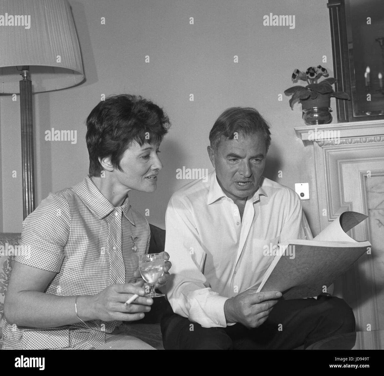 Actor James Mason - alongside author Penelope Mortimer - as he deliberates over the film script of 'The Pumpkin Eater', a new film in which he is to star with Anne Bancroft. The film is based on Penelope Mortimer's best-selling novel and has been adapted for the screen by Harold Pinter. Stock Photo