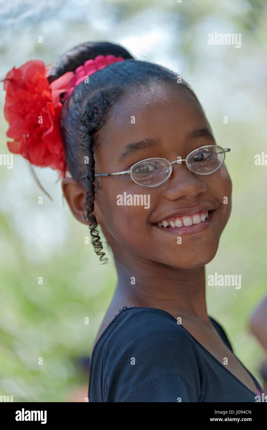 Havana Portrait Of A Smiley Black Girl Wearing Glasses And A Red Flower On Her Head Cuba Stock Photo Alamy