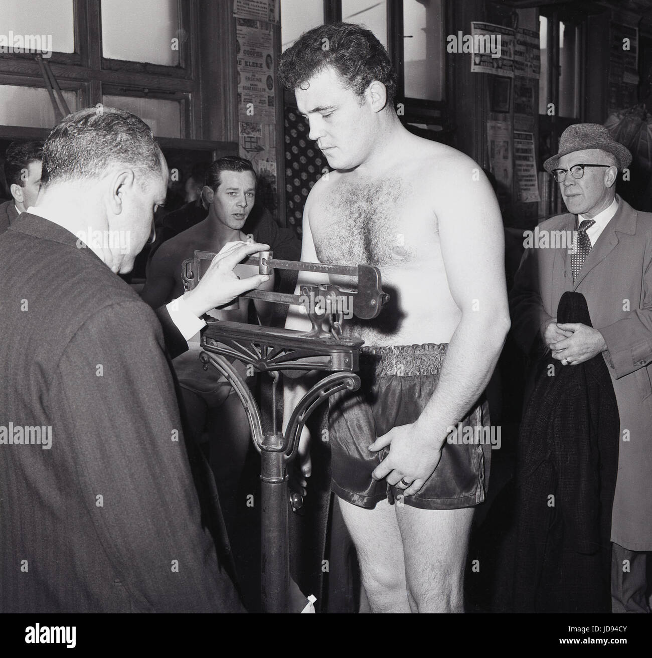 1964, the gym at the famous Thomas A Beckett public house on the Old Kent Road, Bermondsey, South London, SE1, England, picture shows a boxer being officially weighed in on mechanical scales before a contest. Stock Photo
