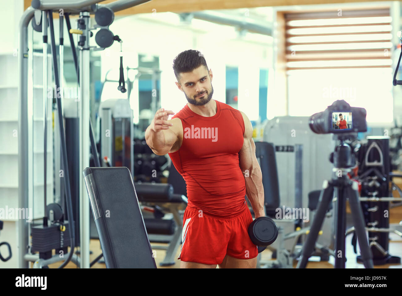 Vlogger sportsman makes a video in the gym Stock Photo