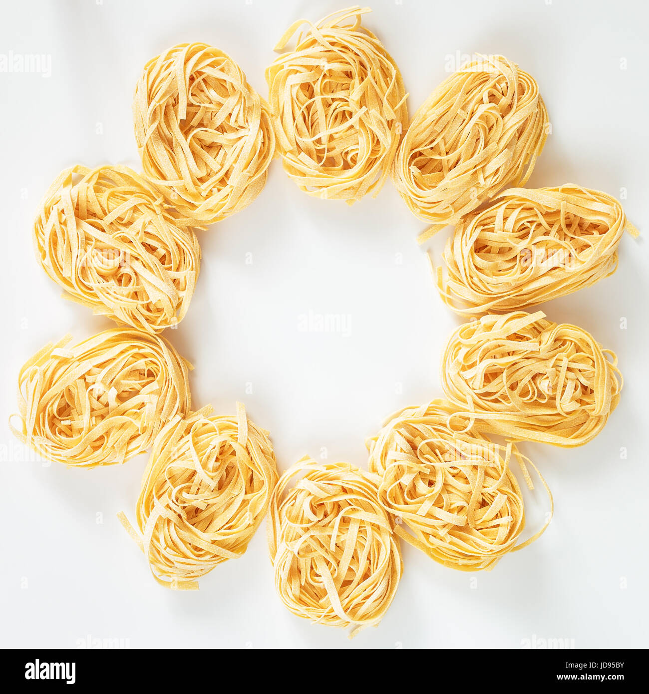 Italian Fettuccine nest pasta on light grey background Stock Photo