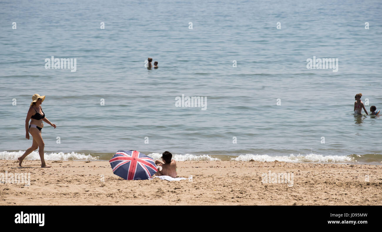 People enjoy the hot weather on the beach in Bournemouth, Dorset, as temperatures are expected to continue to soar this week as the country basks in a heatwave. Stock Photo