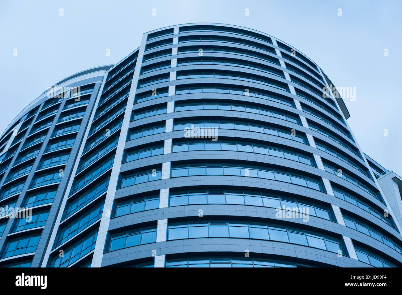 Office modern building on the sky background Stock Photo - Alamy
