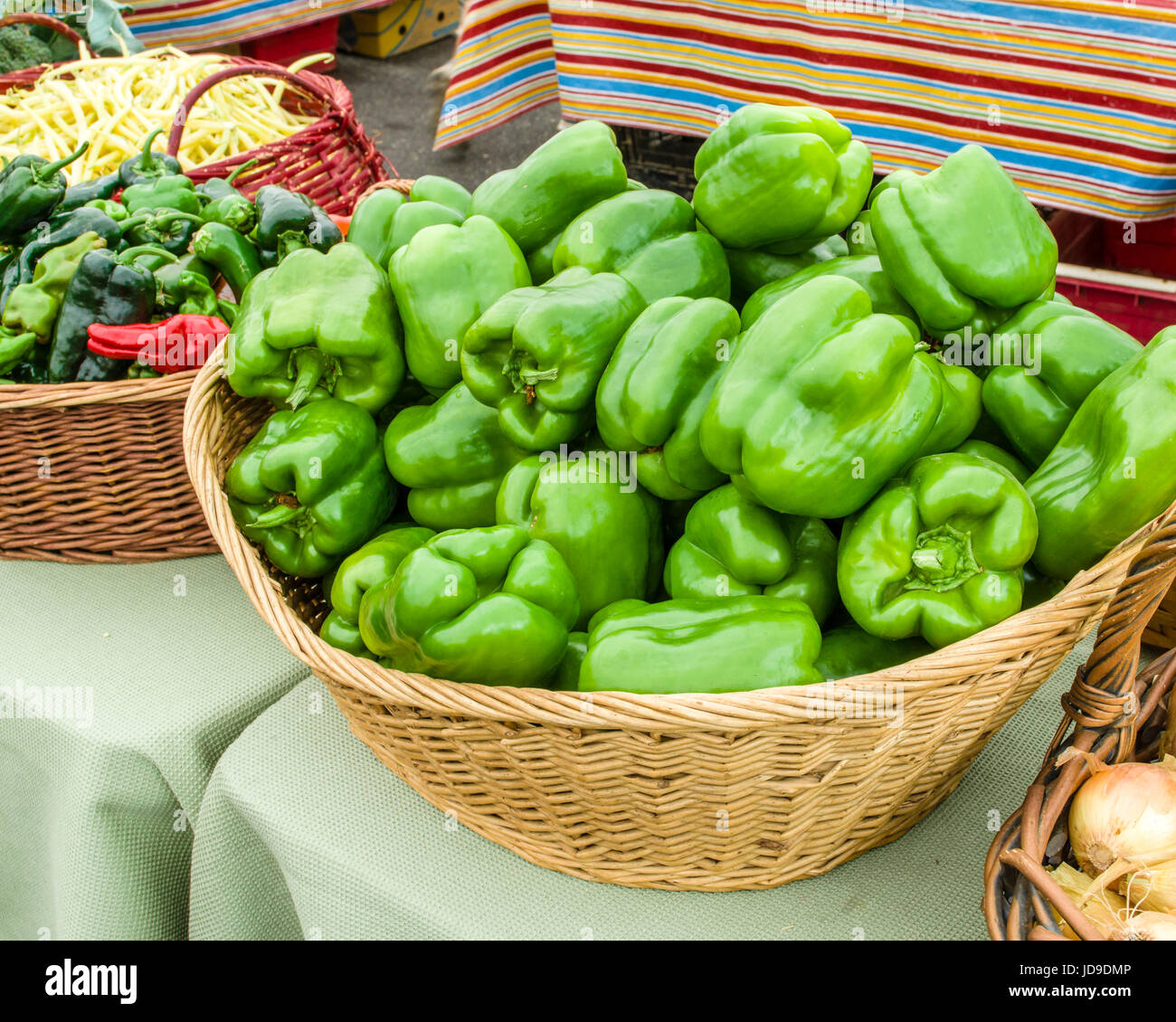 Basket of fresh green peppers at the market Stock Photo
