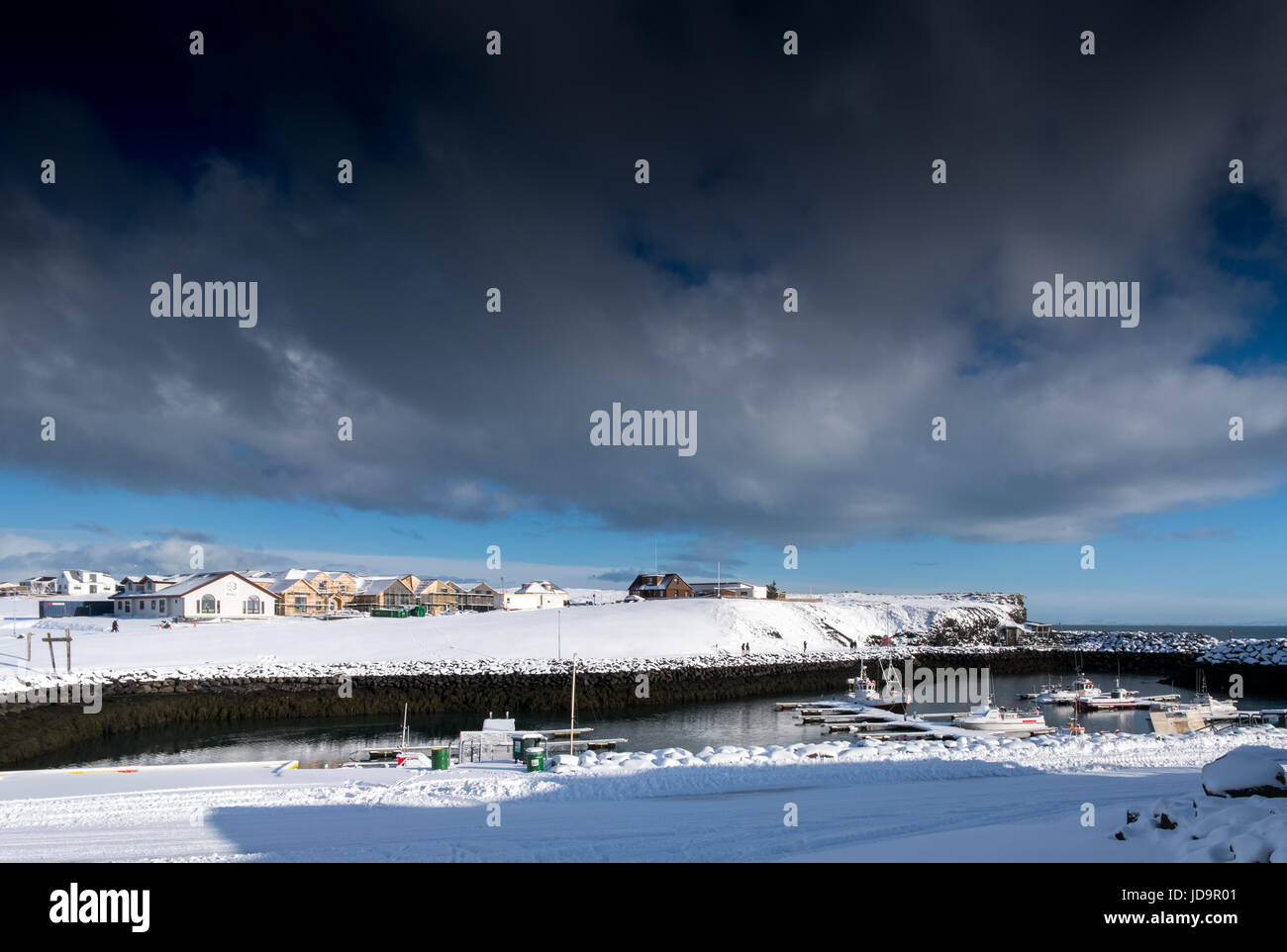 Small town buildings and boats in snow and stormy sky, Iceland, Europe. Iceland nature 2017 winter cold Stock Photo