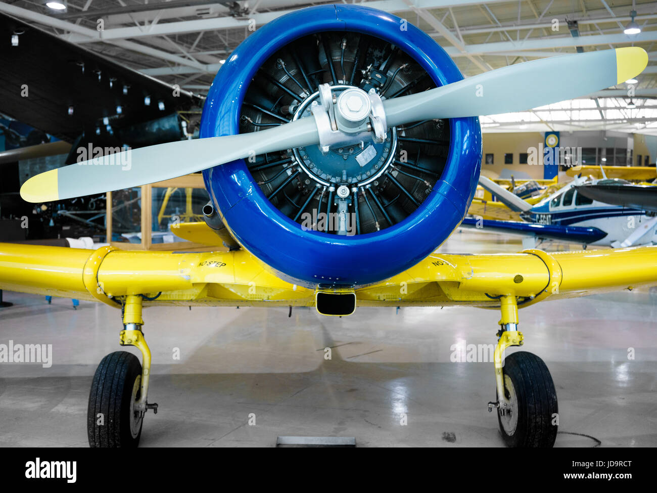Front view of restored, stationary propeller aeroplane, indoors, at day