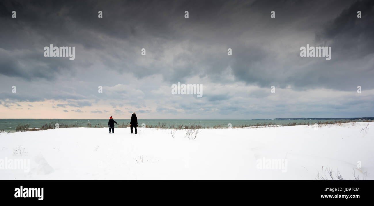 Mother and son walking in snow covered landscape near water ontario canada winter cold 2017 snow Stock Photo